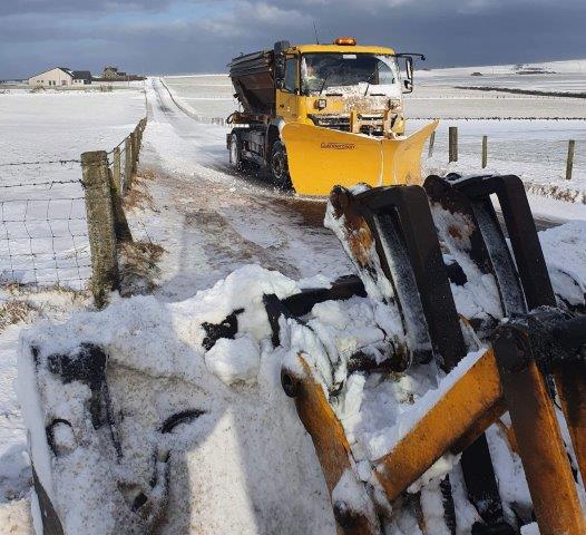 a snow plough clearing through snow
