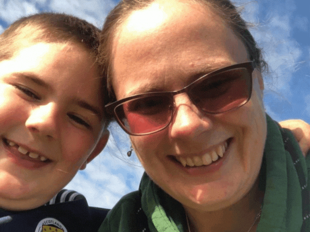 a lady and a boy smiling at the camera