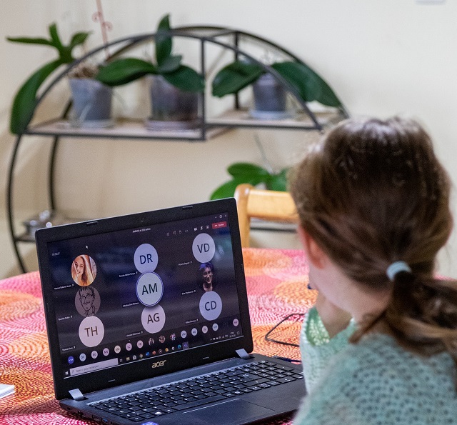 a girl in front of a computer screen